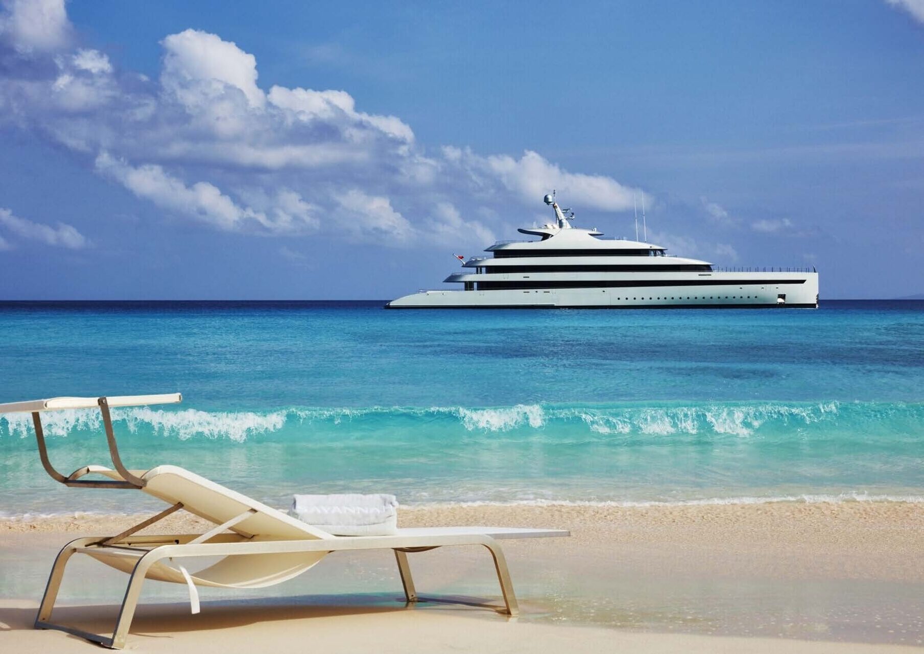 Luxury yacht anchored at sunset near Es Vedrà island