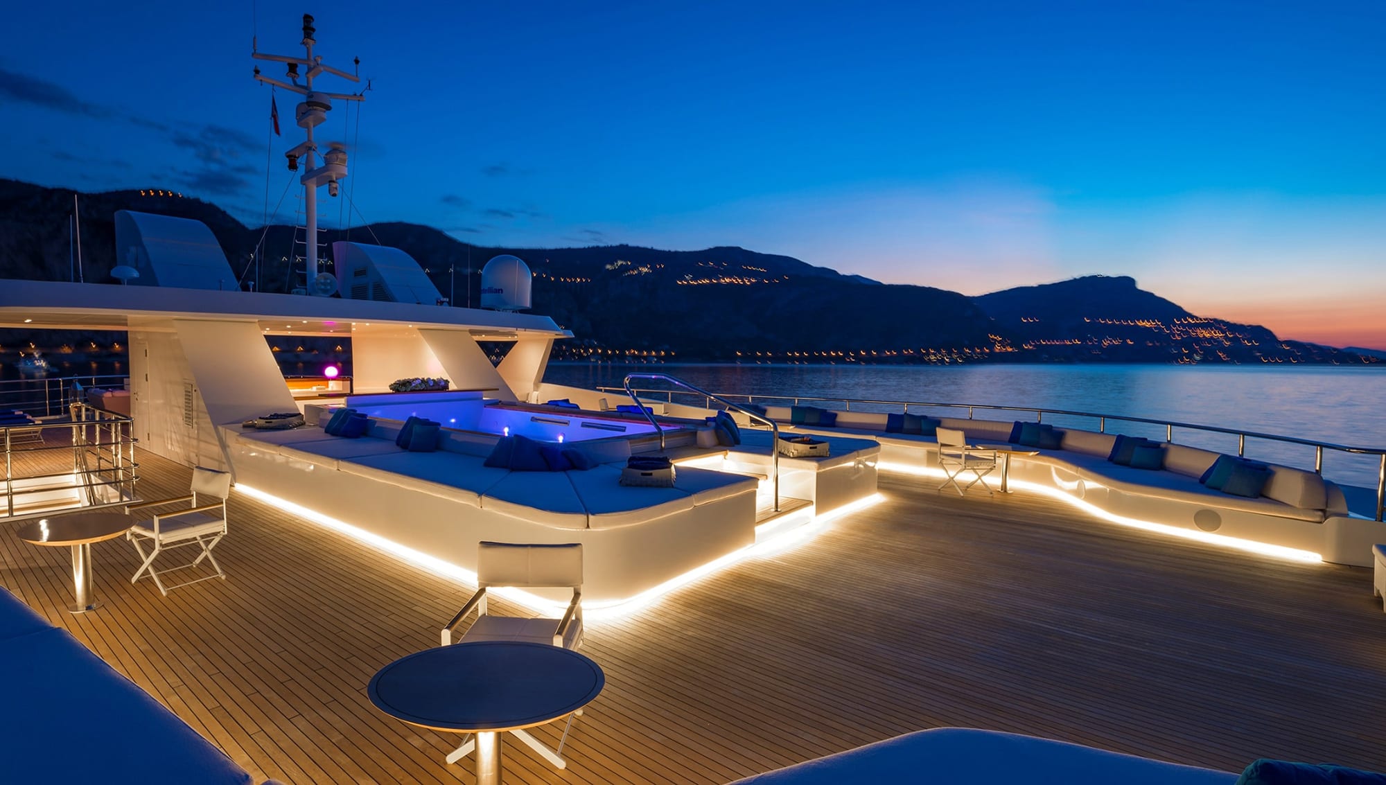 Luxury yacht anchored at sunset near Es Vedrà island