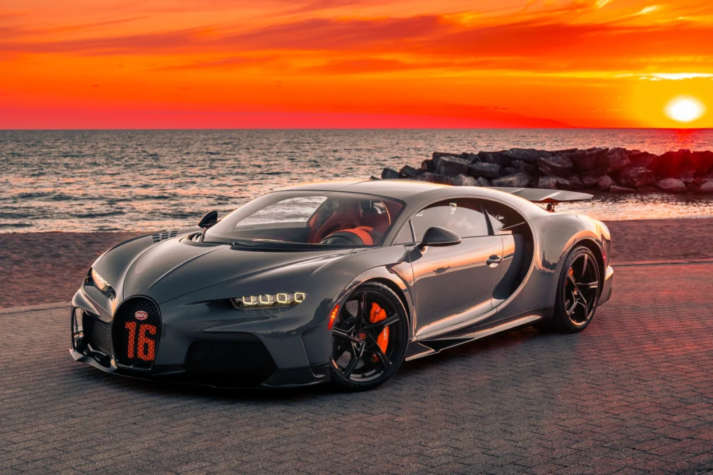 Bugatti Chiron hypercar glowing under Ibiza sunset – ultimate luxury rental experience by King Luxury Ibiza